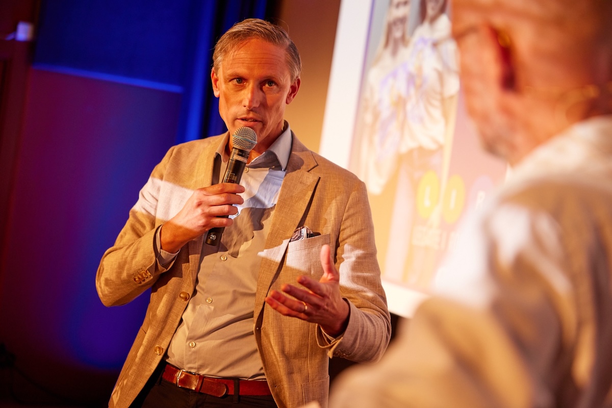Rasmus Roos, VD Sparbanken Skåne, står på scenen och pratar med moderator Anders Mildner.